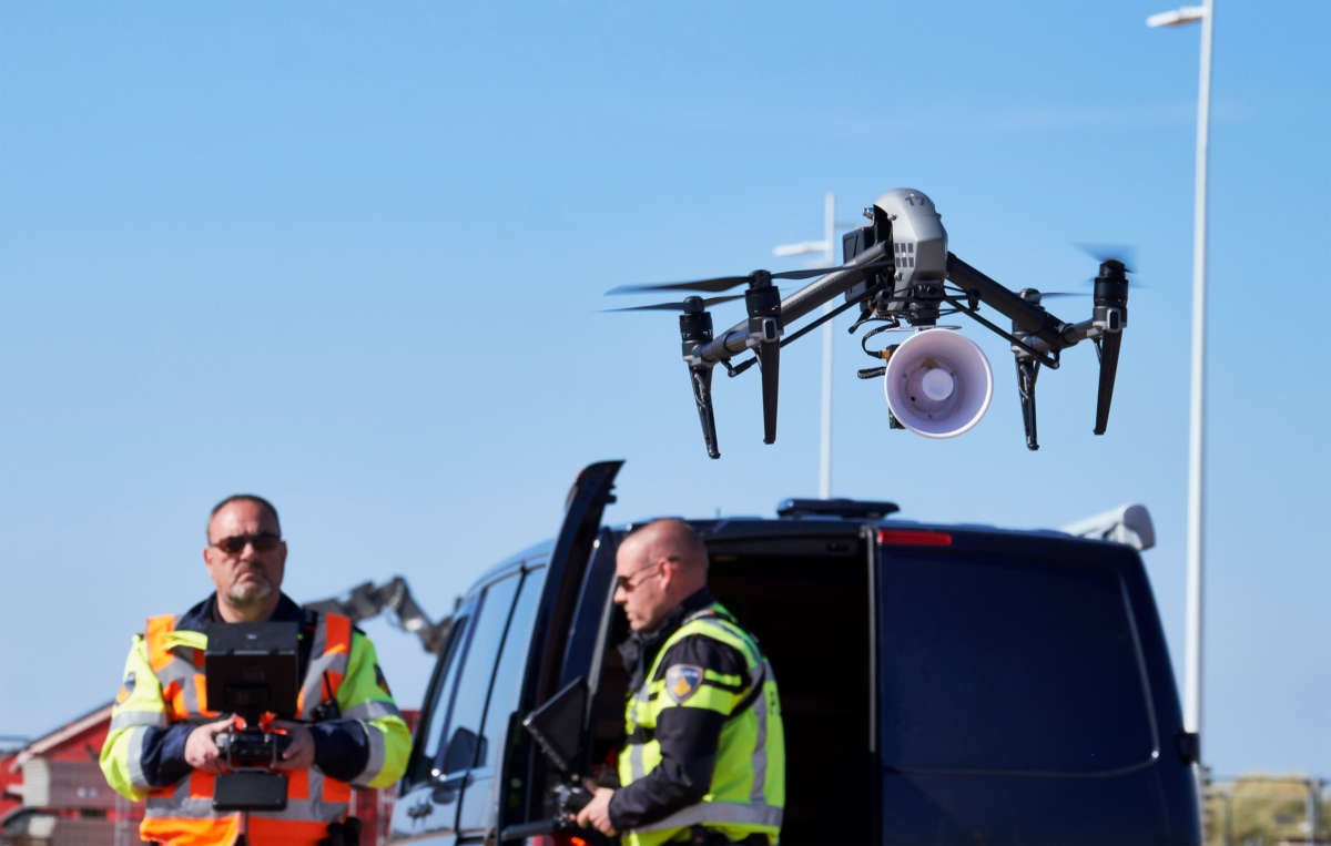 Dutch police officers fly a drone above the seafront of The Hague beach to warn people to keep distance to others amid the COVID-19 pandemic on April 4, 2020, in The Hague, The Netherlands.