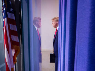 Donald Trump stands across from his own reflection