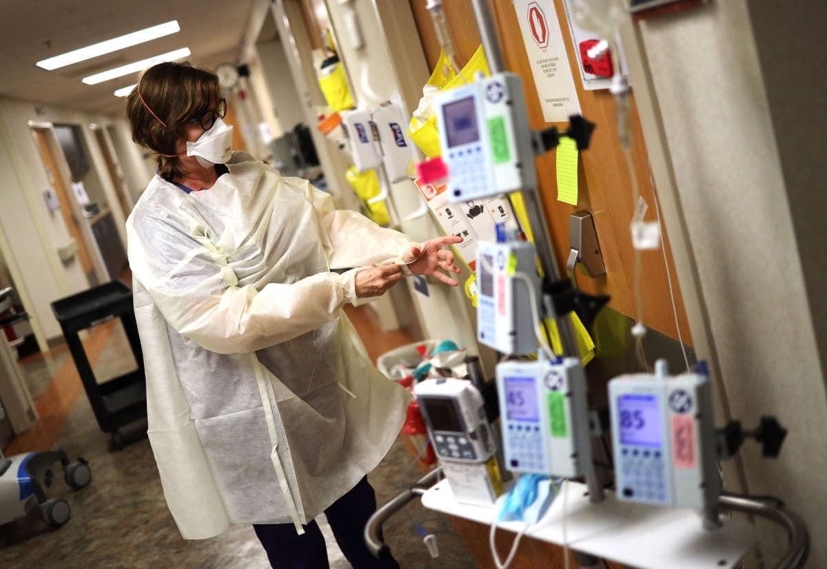 A nurse in the Intensive Care Unit of MedStar St. Mary's Hospital dons personal protective equipment before entering a coronavirus patient's room, April 8, 2020, in Leonardtown, Maryland.