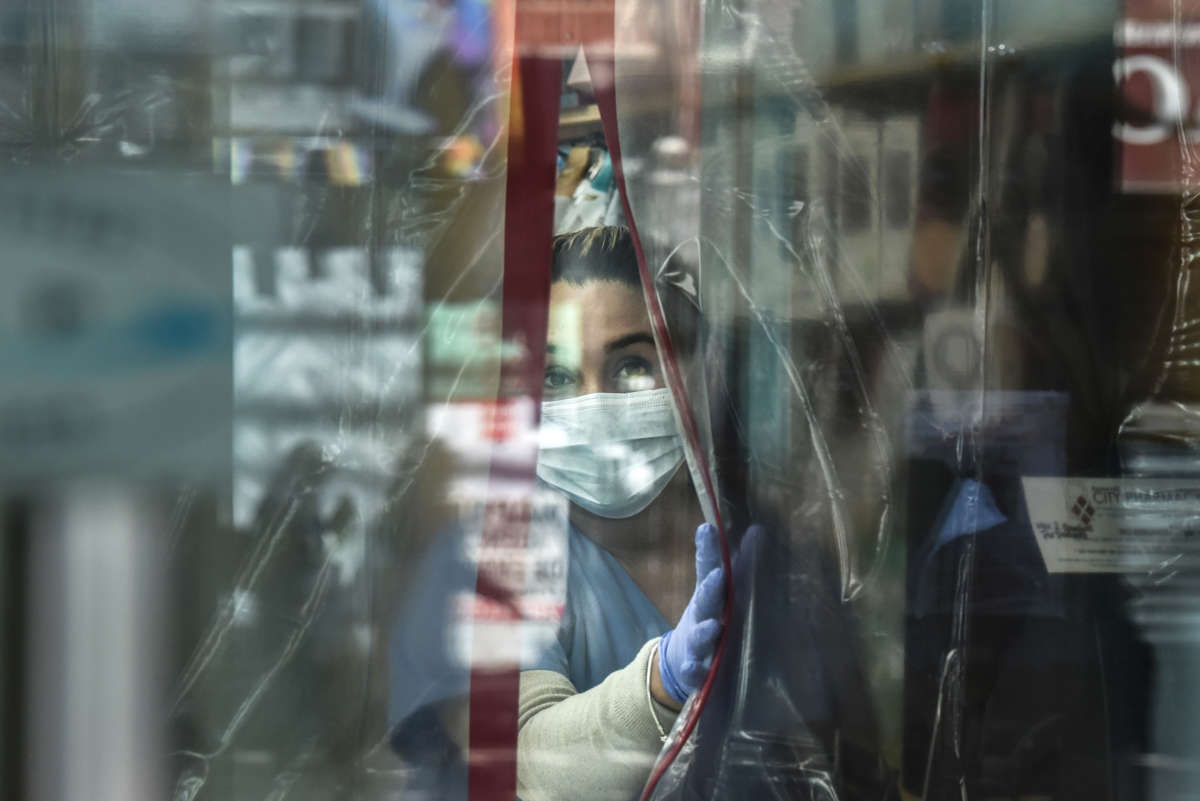A pharmacist works while wearing personal protective equipment in the Elmhurst neighborhood on April 1, 2020, in New York City.
