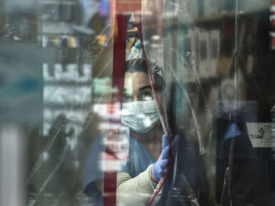 A pharmacist works while wearing personal protective equipment in the Elmhurst neighborhood on April 1, 2020, in New York City.