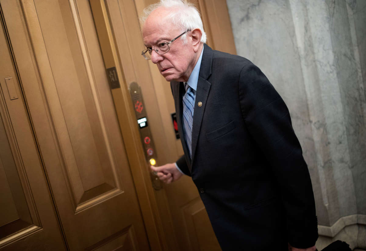 Bernie Sanders pushes a button for an elevator
