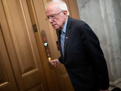 Bernie Sanders pushes a button for an elevator