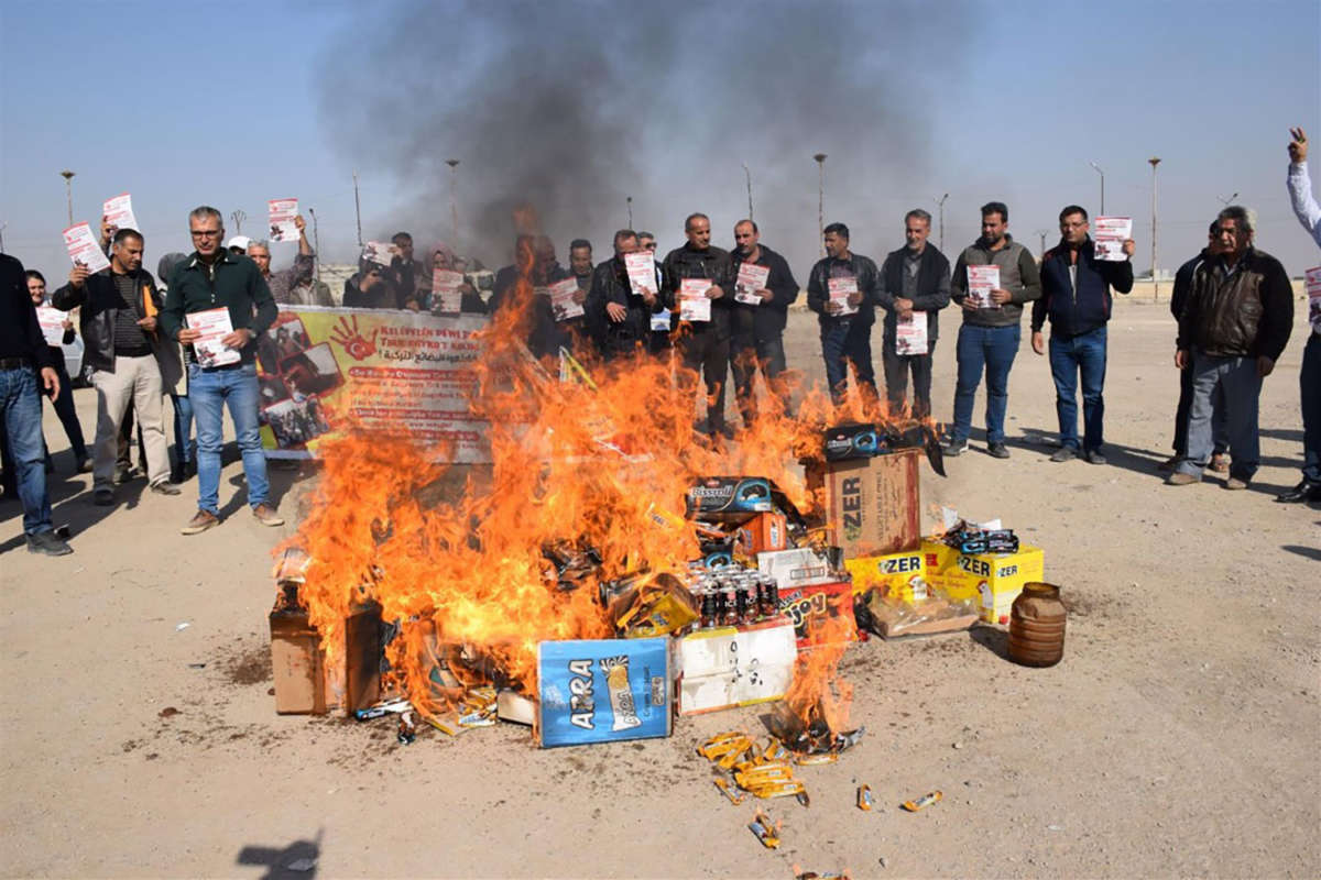 Following the invasion of Rojava, people burn Turkish products in Manbij.