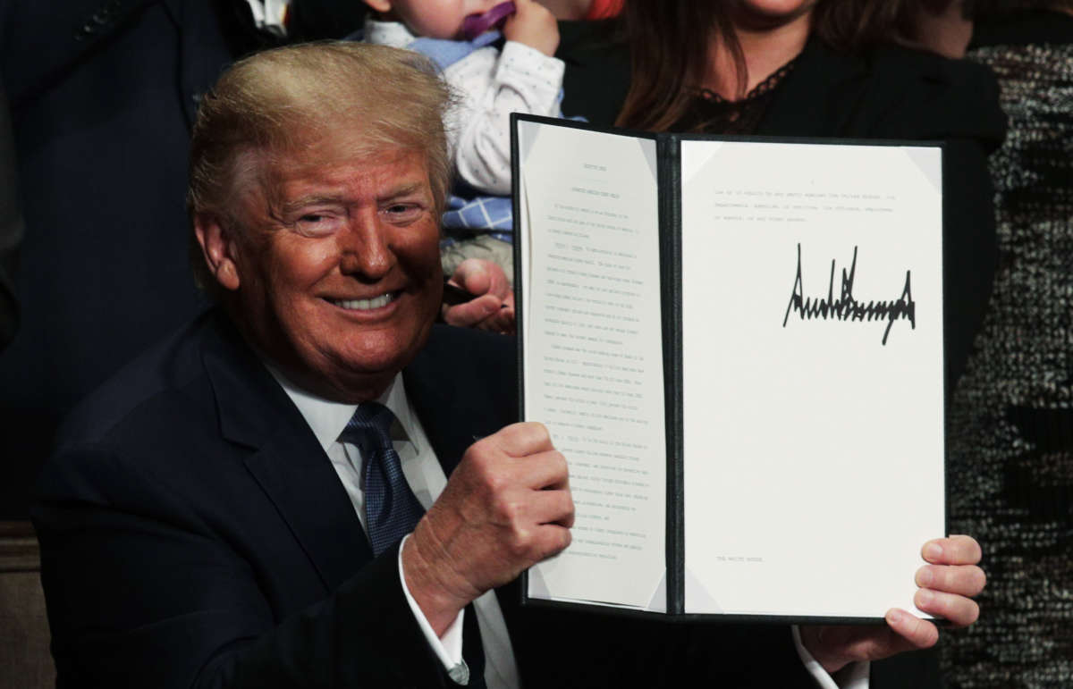 President Trump displays an executive order he has just signed during an event at the Ronald Reagan Building and International Trade Center, July 10, 2019, in Washington, D.C.