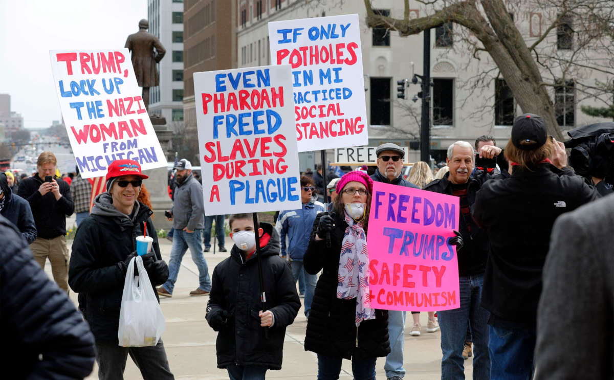 People protest against excessive quarantine amid the COVID-19 pandemic at the Michigan State Capitol in Lansing, Michigan, on April 15, 2020.