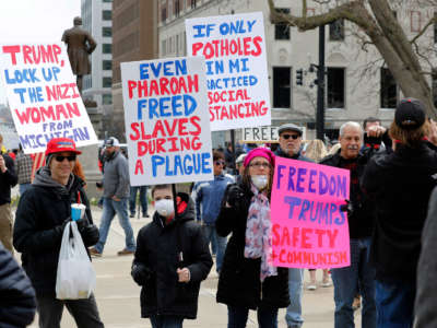 People protest against excessive quarantine amid the COVID-19 pandemic at the Michigan State Capitol in Lansing, Michigan, on April 15, 2020.