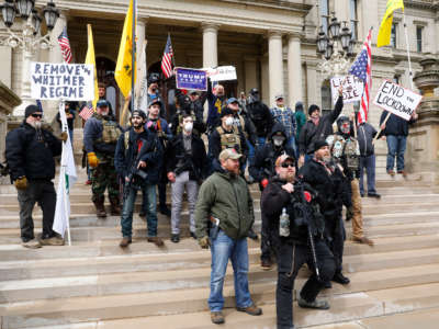 People take part in a protest for "Michiganders Against Excessive Quarantine" at the Michigan State Capitol in Lansing, Michigan, on April 15, 2020.