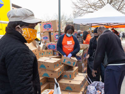 People pick up food for distribution by The Campaign Against Hunger amid the COVID-19 pandemic in the Brooklyn neighborhood of Bedford-Stuyvesant. This neighborhood is one of the poorest in the city and one of the hardest hit by the epidemic.