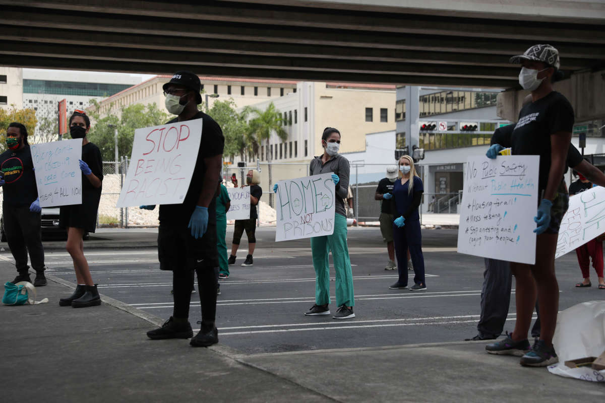 Volunteers, health care workers and doctors participate in a protest against what they say is the city's and county's poor response to helping the homeless during the coronavirus outbreak on April 17, 2020, in Miami, Florida.