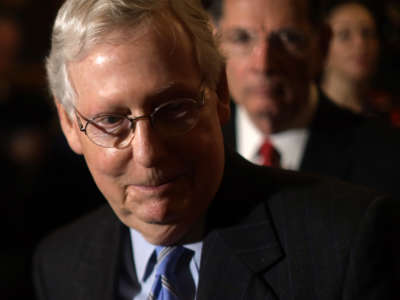 Senate Majority Leader Mitch McConnell listens during a news briefing at the U.S. Capitol on February 25, 2020, in Washington, D.C.