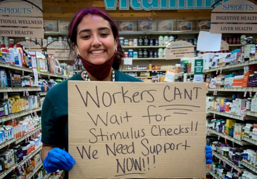 A worker at the Sprouts Farmers Market in McAllen, Texas, protests for hazard pay and coronavirus-safe working conditions.