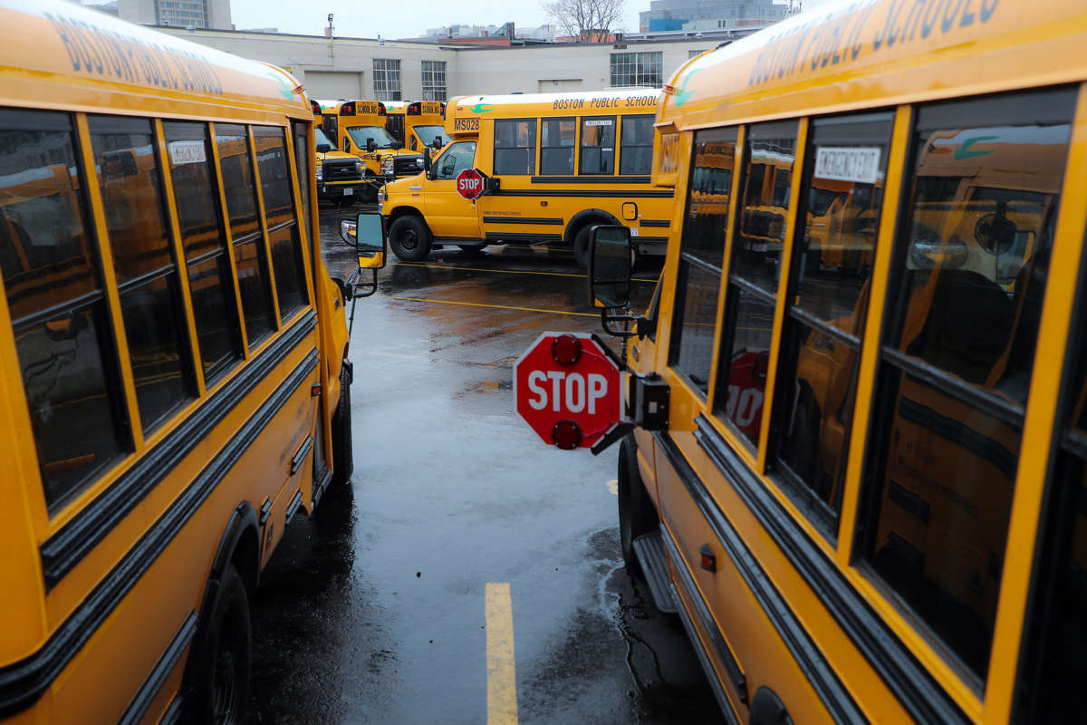 Boston school buses parked in the yard at First Student Inc. in Boston's Roxbury on April 21, 2020, after schools have been ordered closed for the remainder of the school year to curb the COVID-19 pandemic.