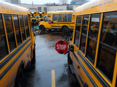 Boston school buses parked in the yard at First Student Inc. in Boston's Roxbury on April 21, 2020, after schools have been ordered closed for the remainder of the school year to curb the COVID-19 pandemic.