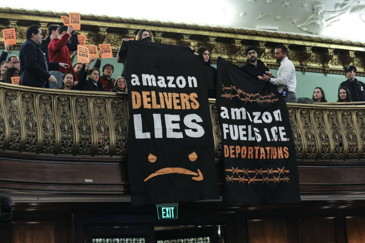 Protesters unfurl anti-Amazon banners from the balcony of a hearing room during a New York City Council Finance Committee hearing titled 'Amazon HQ2 Stage 2: Does the Amazon Deal Deliver for New York City Residents?' at New York City Hall, January 30, 2019, in New York City.