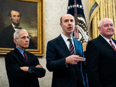National Institute of Allergy and Infectious Diseases Director Anthony Fauci, Secretary of Labor Eugene Scalia and Agriculture Secretary Sonny Perdue attend a bill signing ceremony for H.R. 748, the CARES Act in the Oval Office of the White House on March 27, 2020, in Washington, D.C.