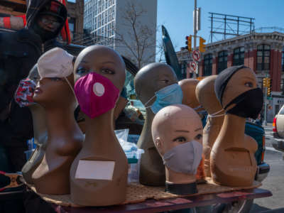 A street vendor sells face masks and coverings outside of the 125th Street MTA station on April 16, 2020, in New York City.