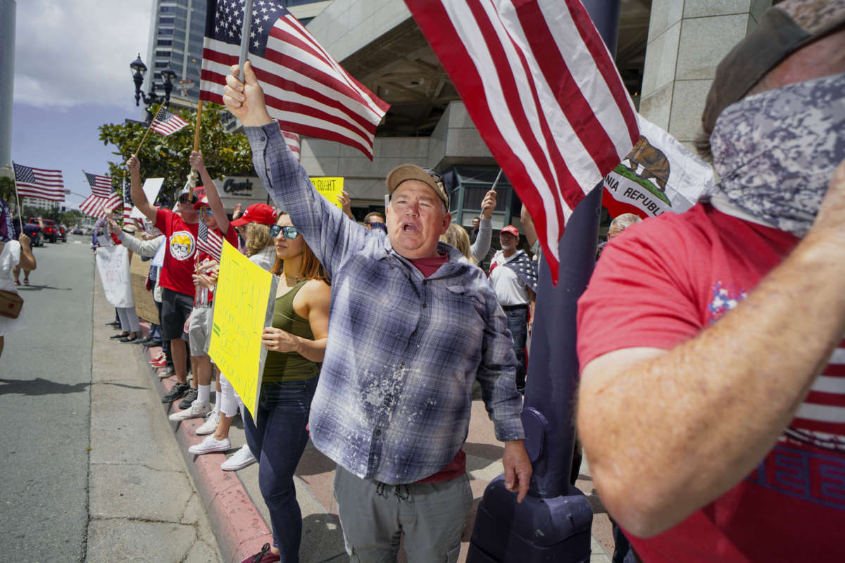 Demonstrators protest during a "Freedom Rally" against Stay-At-Home Directives on April 18, 2020, in San Diego, California.