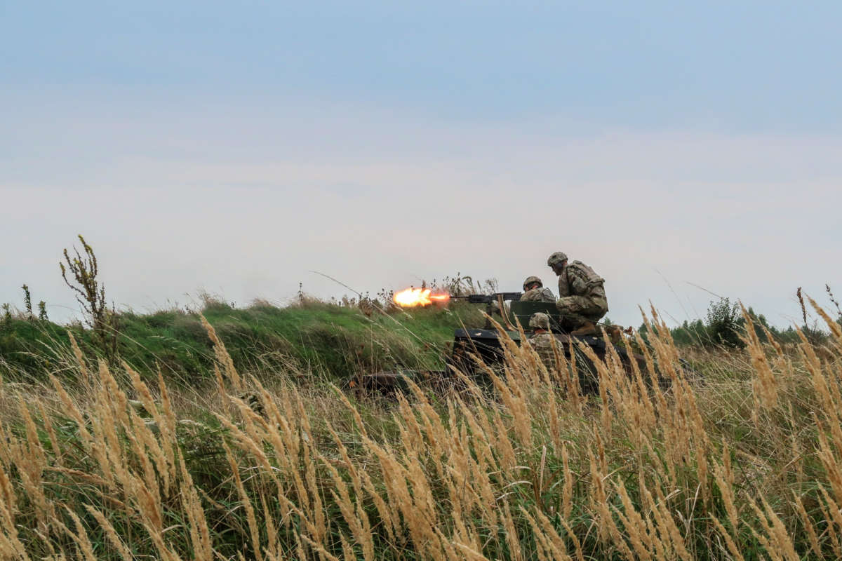 soldiers fire a gun