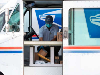 Mail carrier Oscar Osorio continues to deliver mail amid the COVID-19 pandemic, on April 29, 2020, in Los Angeles, California.