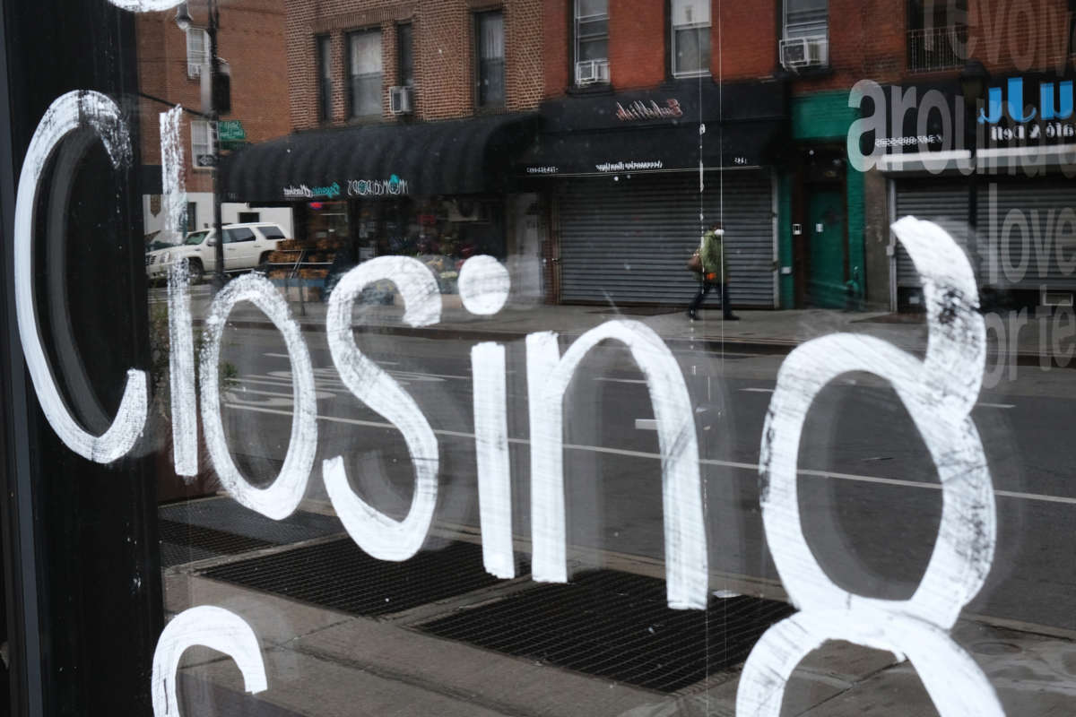 A person walks past a closed business in Brooklyn on April 23, 2020, in New York City.