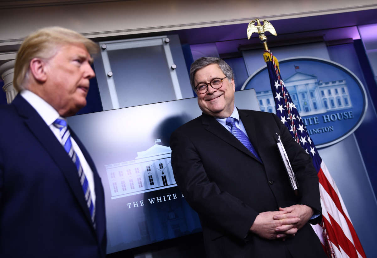 President Trump arrives as Attorney General William Barr looks on during the daily briefing on COVID-19 at the White House on March 23, 2020, in Washington, D.C.