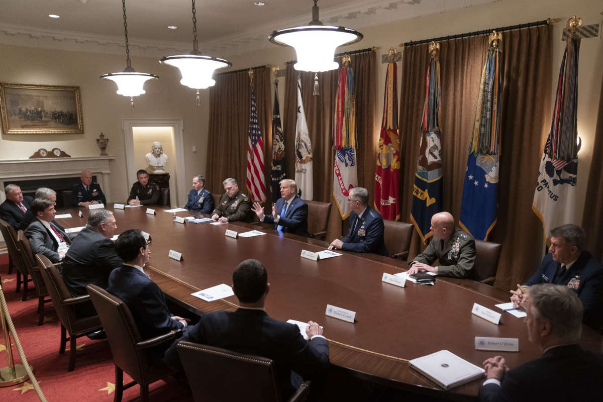 Trump and associated republicans sit around a table