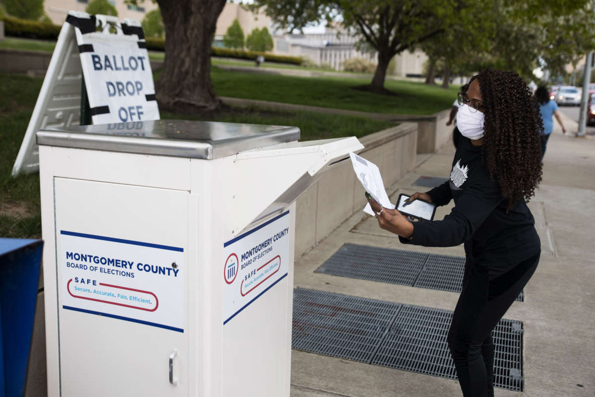 An Ohio voter drops off her ballot at the Board of Elections in Dayton, Ohio, on April 28, 2020.