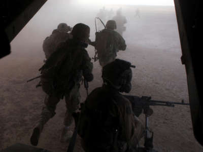 U.S. Marines and Georgian soldiers exit a Marine Corps MV-22 Osprey during an operation in Helmand province, Afghanistan, on September 23, 2013.