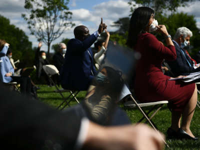 Reporters wearing masks ask questions as President Trump speaks during a news conference on COVID-19 in the Rose Garden of the White House in Washington, D.C., on May 11, 2020.