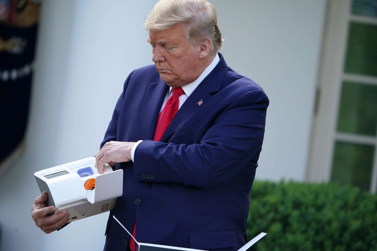 President Trump holds a 5-minute test for COVID-19 from Abbott Laboratories during the daily briefing on the novel coronavirus, COVID-19, in the Rose Garden of the White House in Washington, D.C., on March 30, 2020.