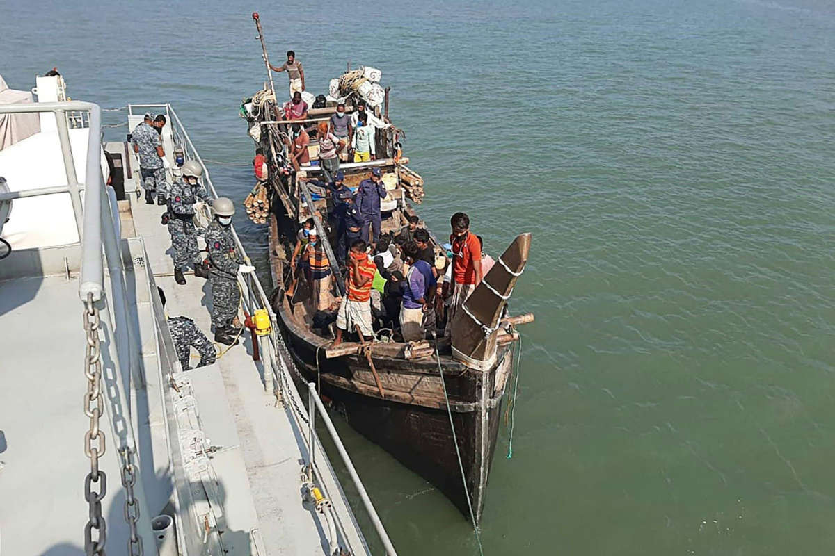 In this picture taken on May 2, 2020, Rohingya refugees stranded at sea are seen on a boat near the coast of Cox's Bazar. Dozens of Rohingya refugees believed to have come from two boats stranded at sea for weeks as they tried to reach Malaysia landed on the Bangladesh coast on May 2, Rohingya community leaders said.