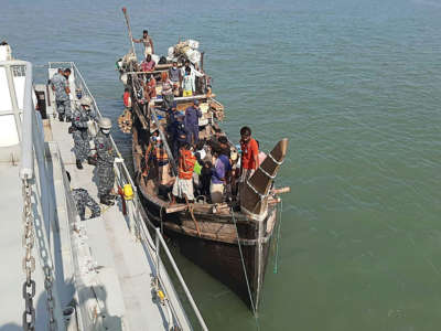 In this picture taken on May 2, 2020, Rohingya refugees stranded at sea are seen on a boat near the coast of Cox's Bazar. Dozens of Rohingya refugees believed to have come from two boats stranded at sea for weeks as they tried to reach Malaysia landed on the Bangladesh coast on May 2, Rohingya community leaders said.