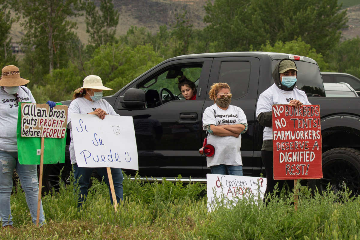 Workers demonstrate during a strike outside of Allan Brothers Fruit on May 16, 2020, in Naches, Washington. Workers from at least six fruit packing facilities in the Yakima County area have gone on strike to protest working conditions amid the COVID-19 pandemic.