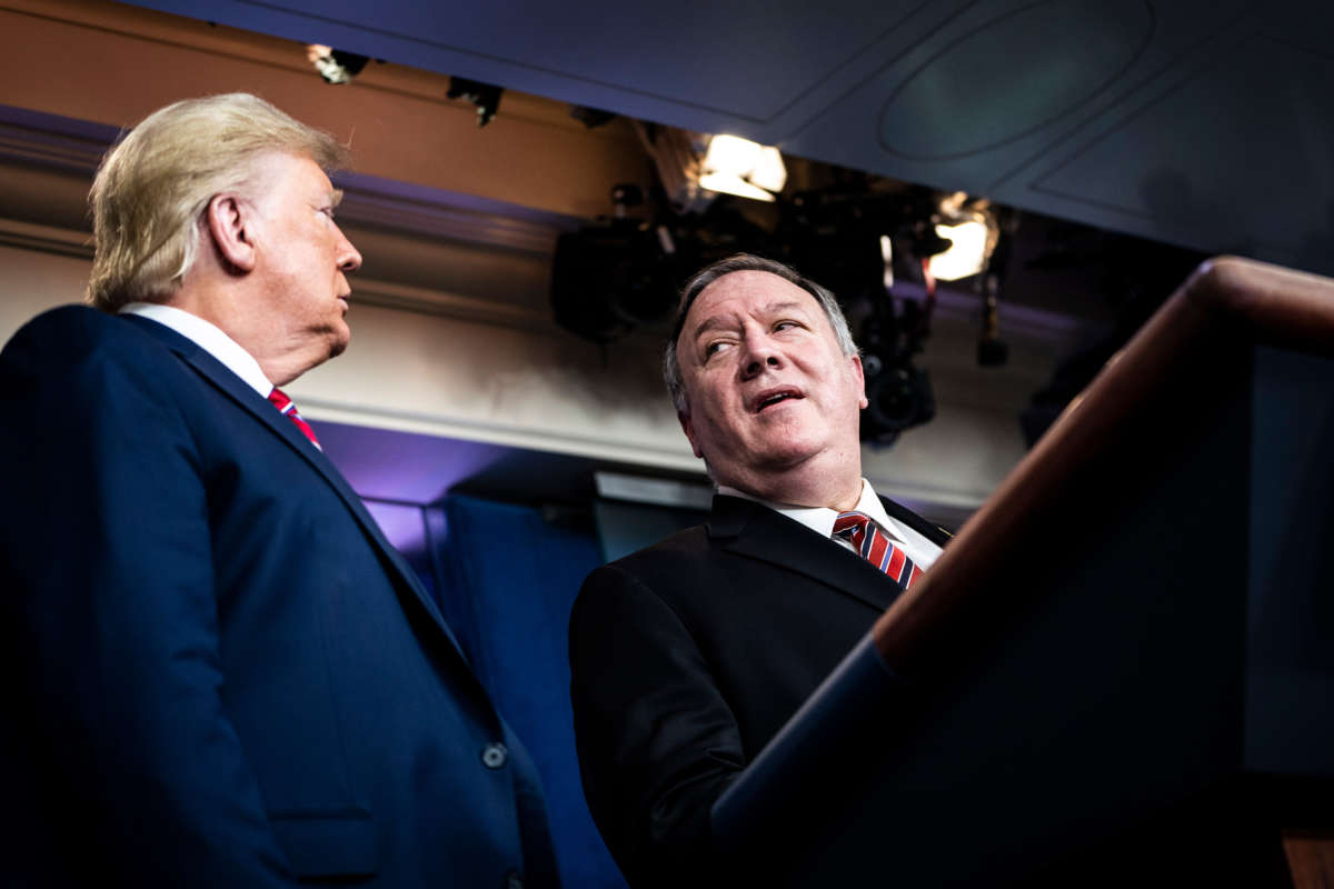 President Trump speaks with Secretary of State Mike Pompeo and the coronavirus task force during a briefing in the James S. Brady Press Briefing Room at the White House on March 20, 2020, in Washington, D.C.