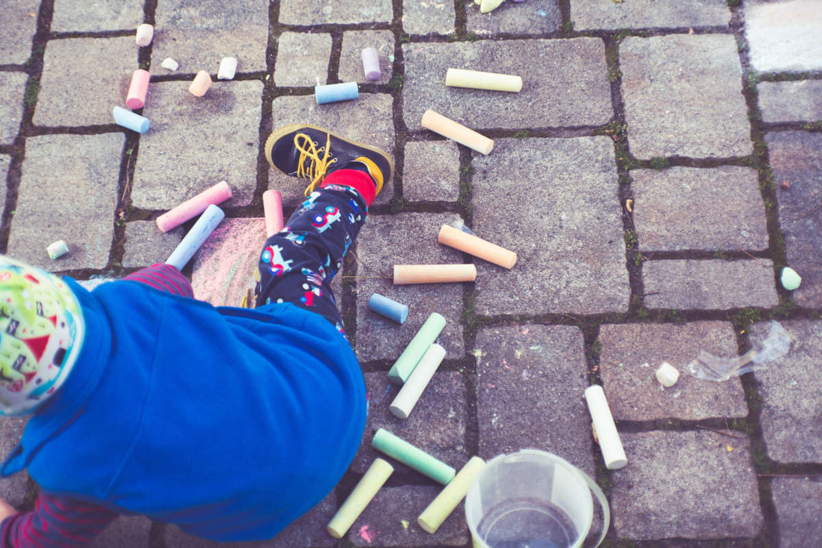 Child playing with street chalk