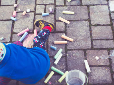 Child playing with street chalk