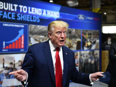 President Trump holds a mask as he speaks during a tour of the Ford Rawsonville Plant in Ypsilanti, Michigan, on May 21, 2020.