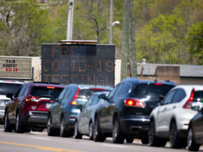 Cars line up for drive through COVID-19 testing on April 18, 2020, in Springfield, Tennessee. Tennessee drive through testing sites now allow those without symptoms to receive testing.