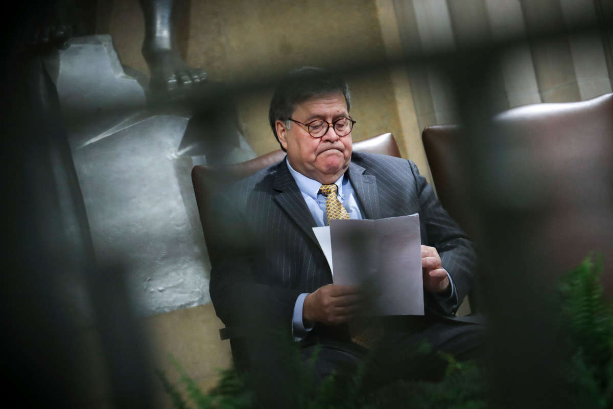 Attorney General William Barr looks over notes during an event at the U.S. Department of Justice on December 3, 2019, in Washington, D.C.
