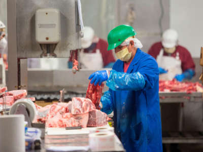 Butchers chop up beef at Jones Meat & Food Services in Rigby, Idaho