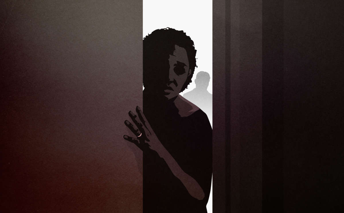 Woman leans through dark doorway with shadow behind her