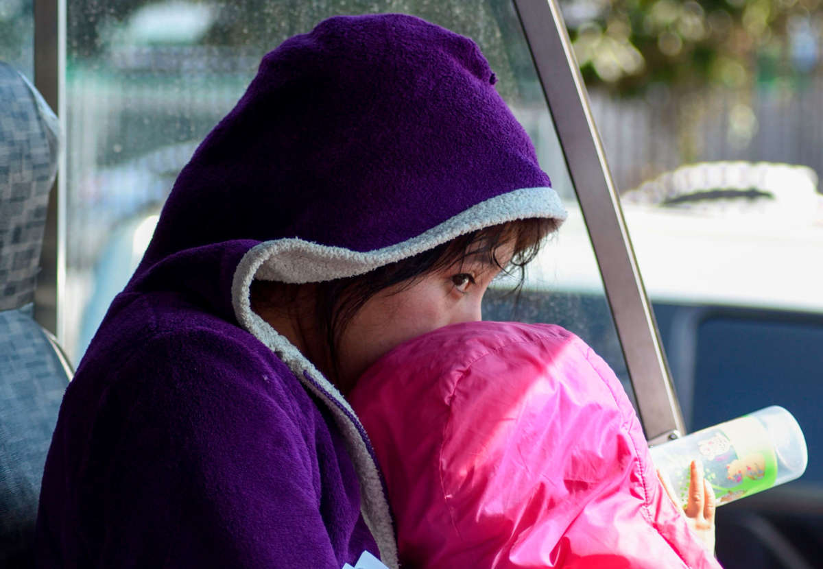 A child sits on a bus with migrants deported from the United States outside the air force base in Guatemala City on December 27, 2019.