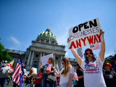 Demonstrators rally outside the Pennsylvania Capitol Building regarding the continued closure of businesses due to the coronavirus pandemic on May 15, 2020, in Harrisburg, Pennsylvania.