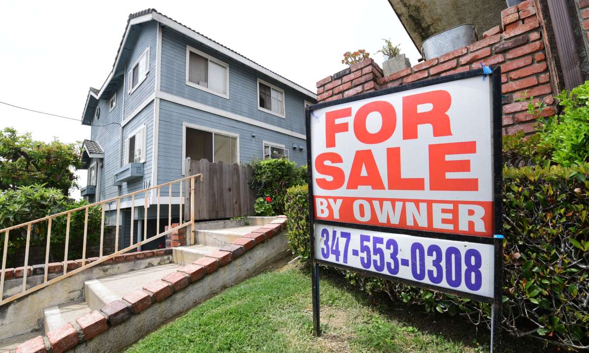 A "For Sale by Owner" sign is posted in front of property in Monterey Park, California, on April 29, 2020.