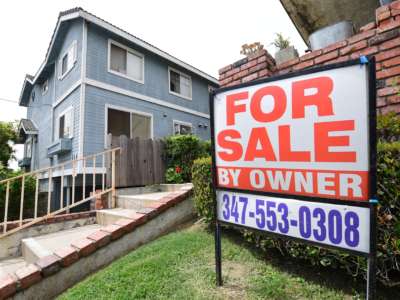 A "For Sale by Owner" sign is posted in front of property in Monterey Park, California, on April 29, 2020.