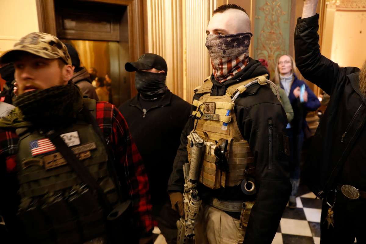 Protesters try to enter the Michigan House of Representative chamber and are being kept out by the Michigan State Police after the American Patriot Rally organized by Michigan United for Liberty protest for the reopening of businesses on the steps of the Michigan State Capitol in Lansing, Michigan, on April 30, 2020.