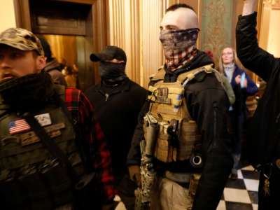 Protesters try to enter the Michigan House of Representative chamber and are being kept out by the Michigan State Police after the American Patriot Rally organized by Michigan United for Liberty protest for the reopening of businesses on the steps of the Michigan State Capitol in Lansing, Michigan, on April 30, 2020.