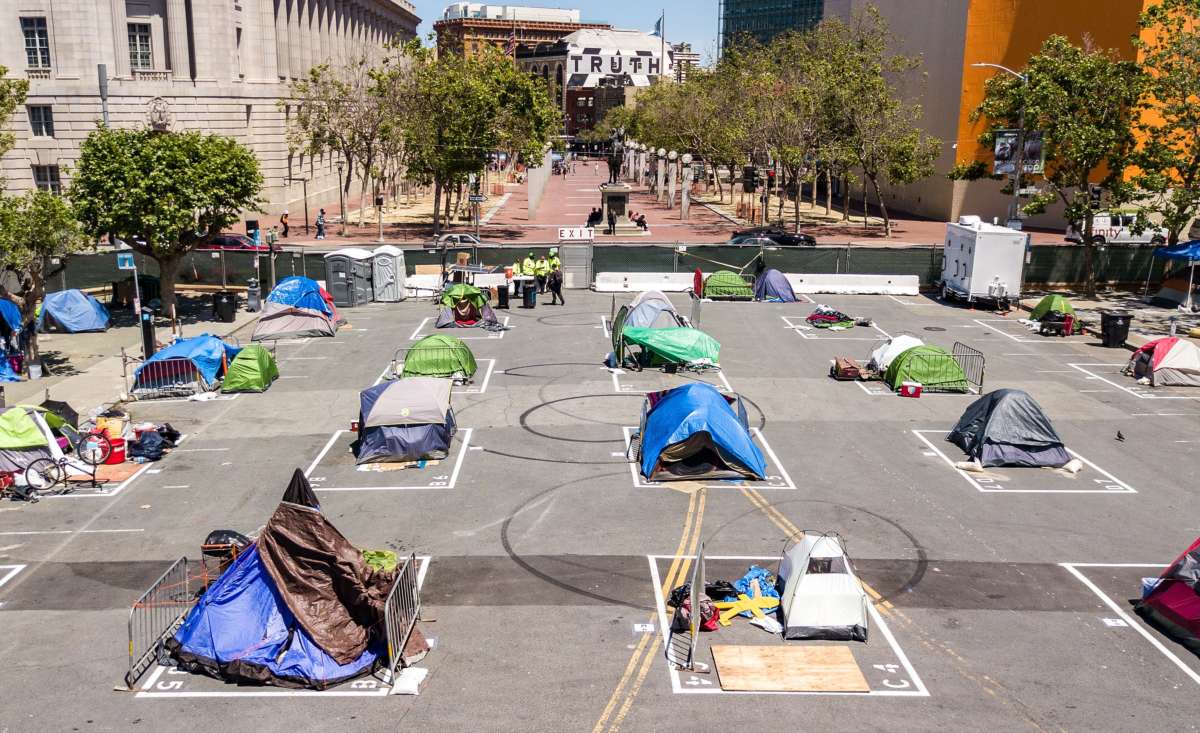 Rectangles are painted on the ground to encourage homeless people to keep social distancing at a city-sanctioned homeless encampment across from City Hall in San Francisco, California, on May 22, 2020, amid the novel coronavirus pandemic.