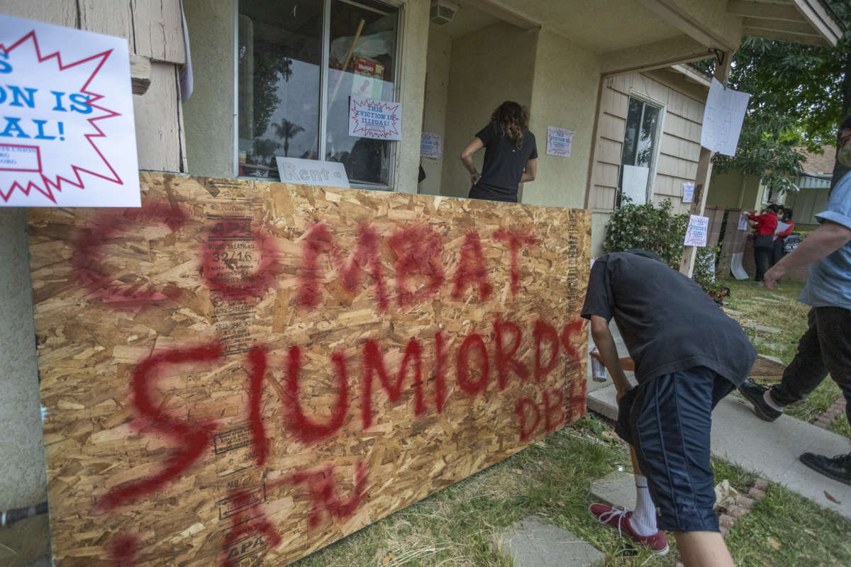 Activists break into the house of Kaotar Dee, to get her and her possessions back into her home of 21 years and for her to make a barricaded stand after being locked out by landlords during the coronavirus pandemic on May 29, 2020, in Los Angeles, California. The city has recently passed the right for tenants to sue landlords who violate restrictions that Los Angeles has placed on evicting renters during the coronavirus crisis.